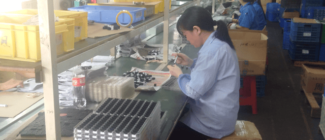 A shanzhai worker in Huaqiangbei, busy making knock-off products A worker in Huaqiangbei, busy making shanzhai phones